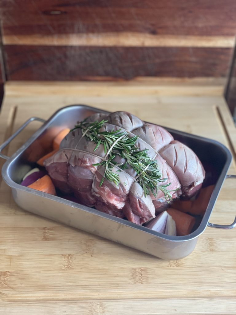 leg of lamb with rosemary and veg in roasting tin